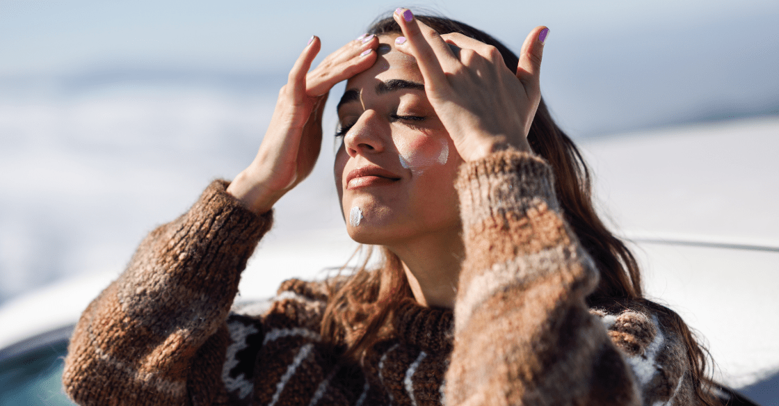 Woman putting on sunscreen