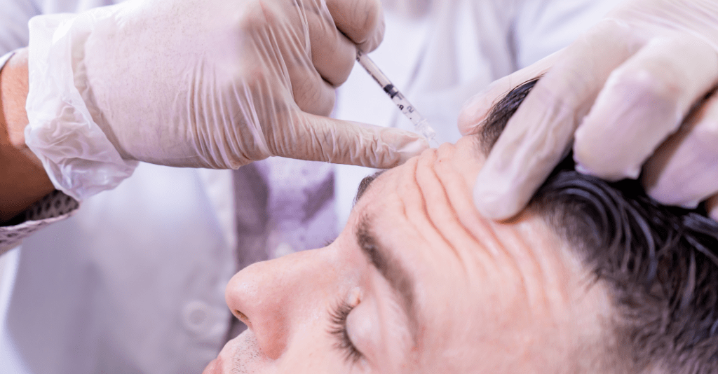 Man getting botox injections in his forehead