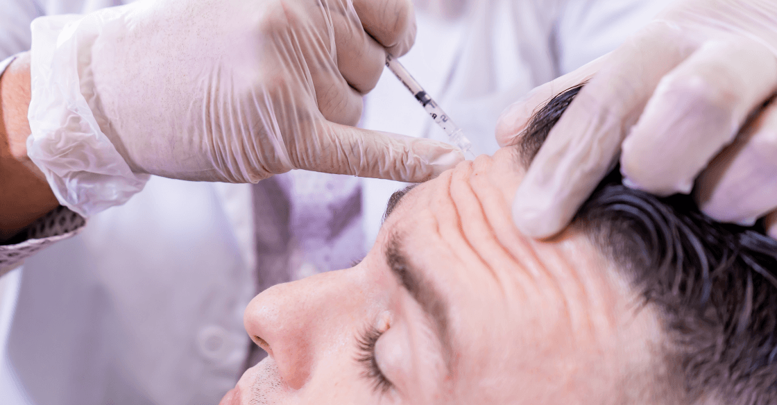 Man getting botox injections in his forehead