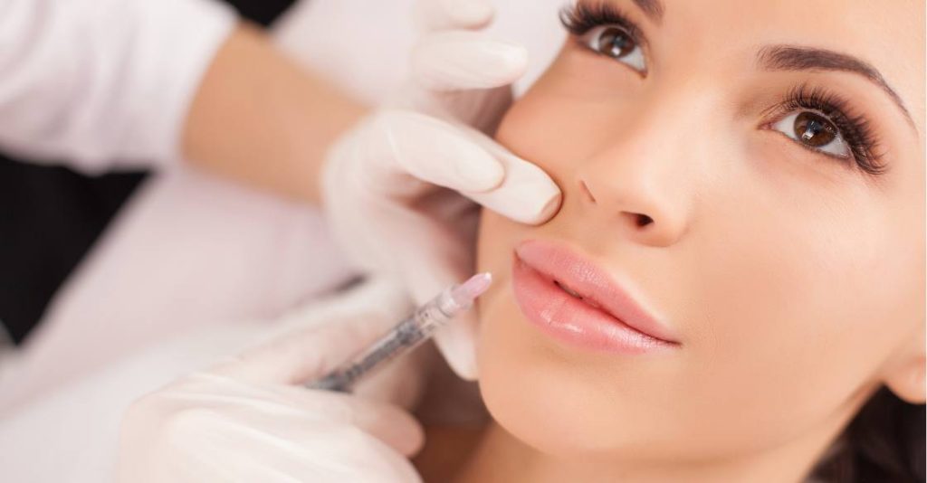 Person receiving dermal filler for smile lines