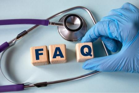 Blocks that spell FAQ surrounded by a stethescope