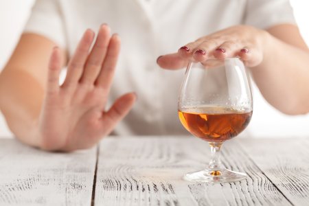 Person refusing to drink alcohol after receiving Botox